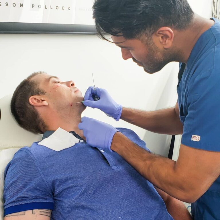 Dr sharma perfoming a jawline augmentation on Man