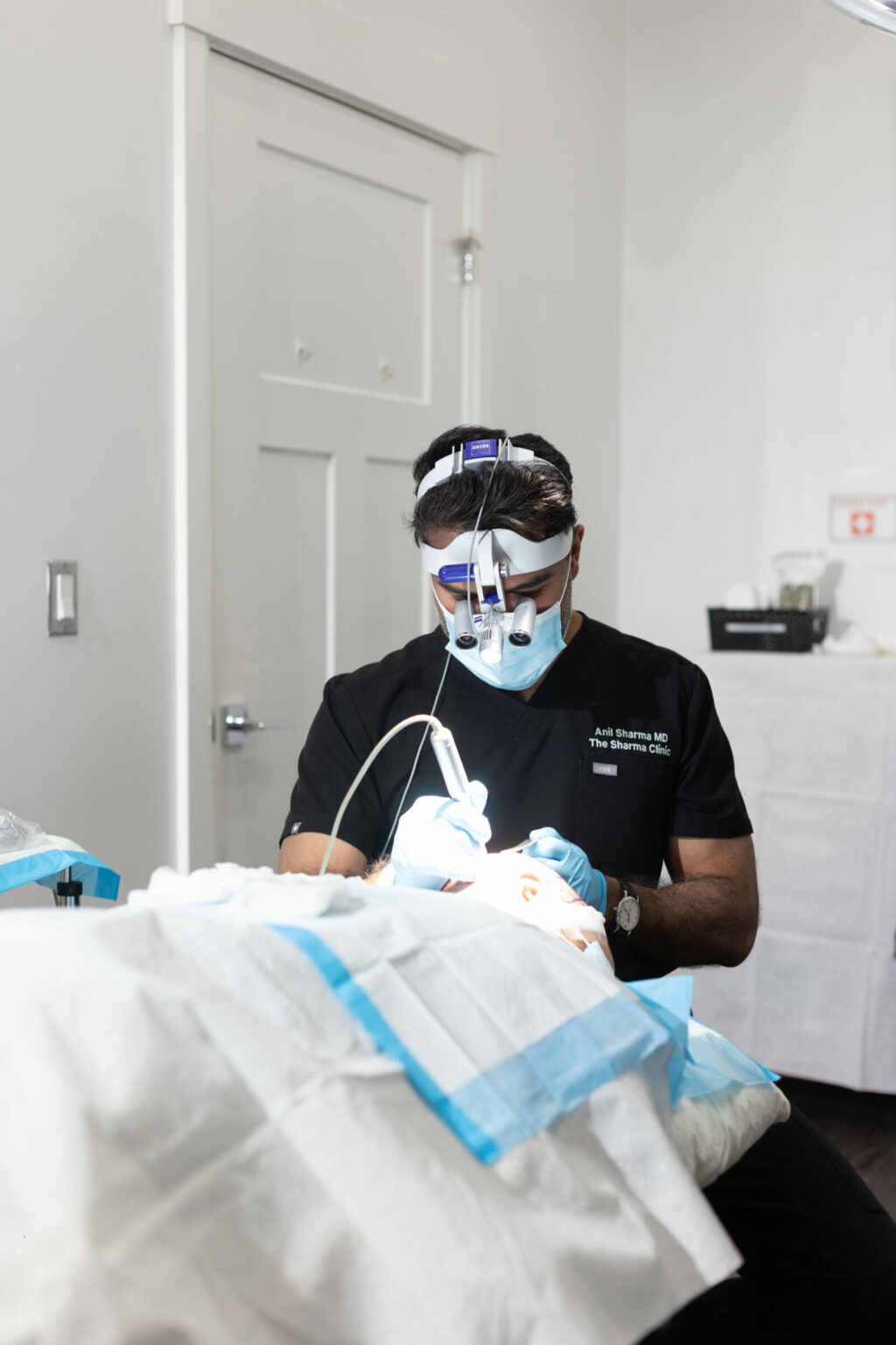Doctor sharma performing hair transplant FUE procedure